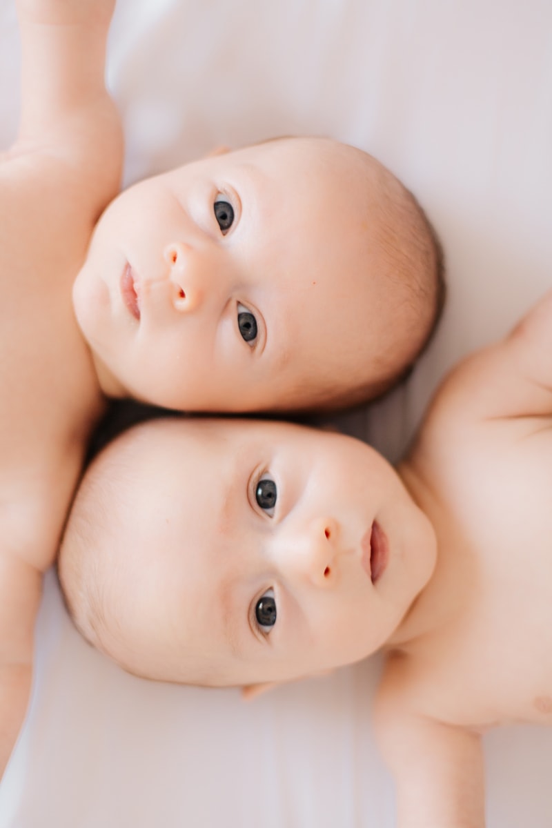 Newborn Photographer, twin babies looking up at the camera