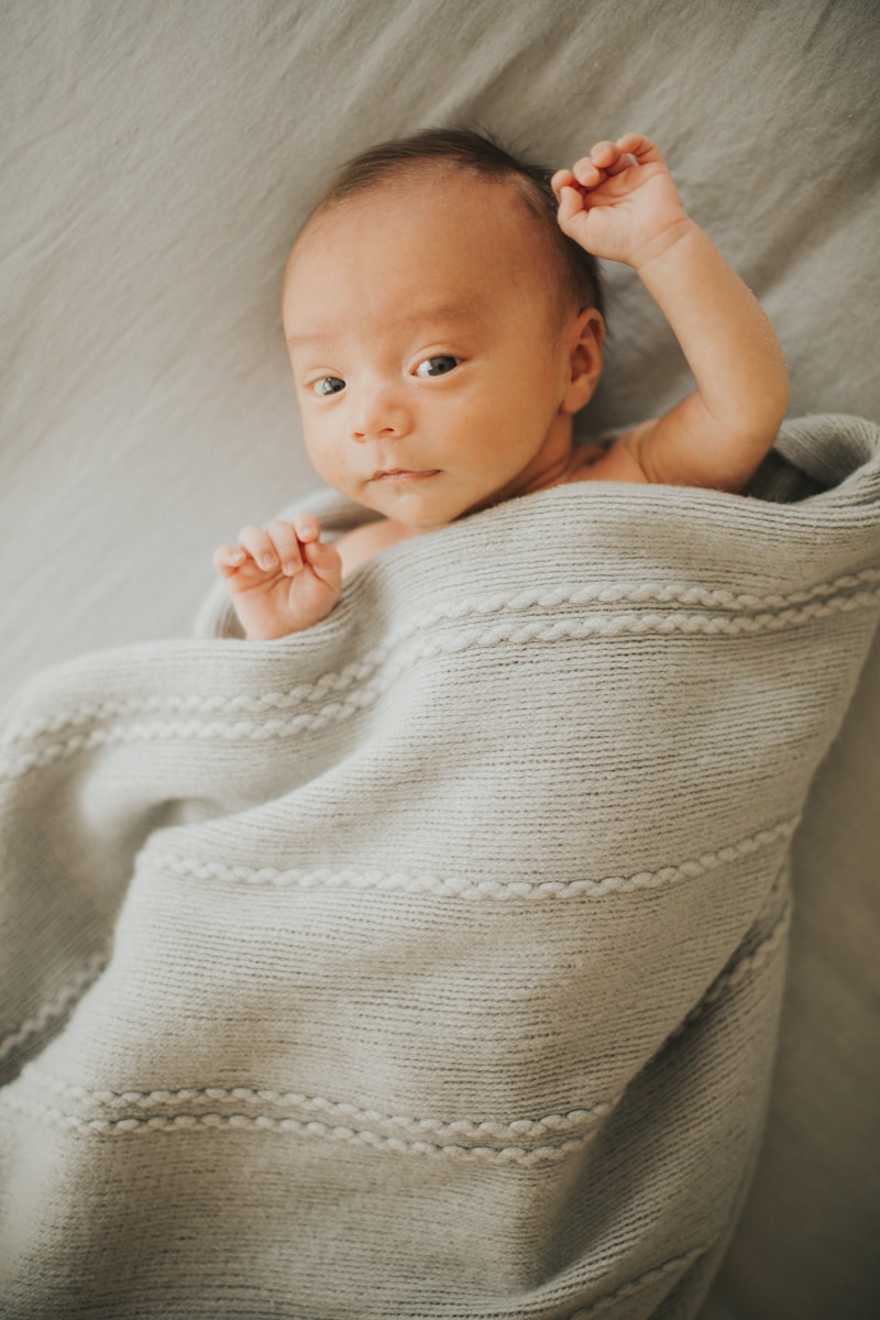 Newborn Photographer, little baby wrapped in grey linen